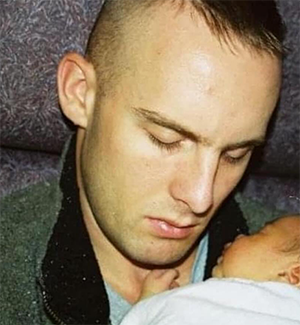 My dad, holding me as a newborn.