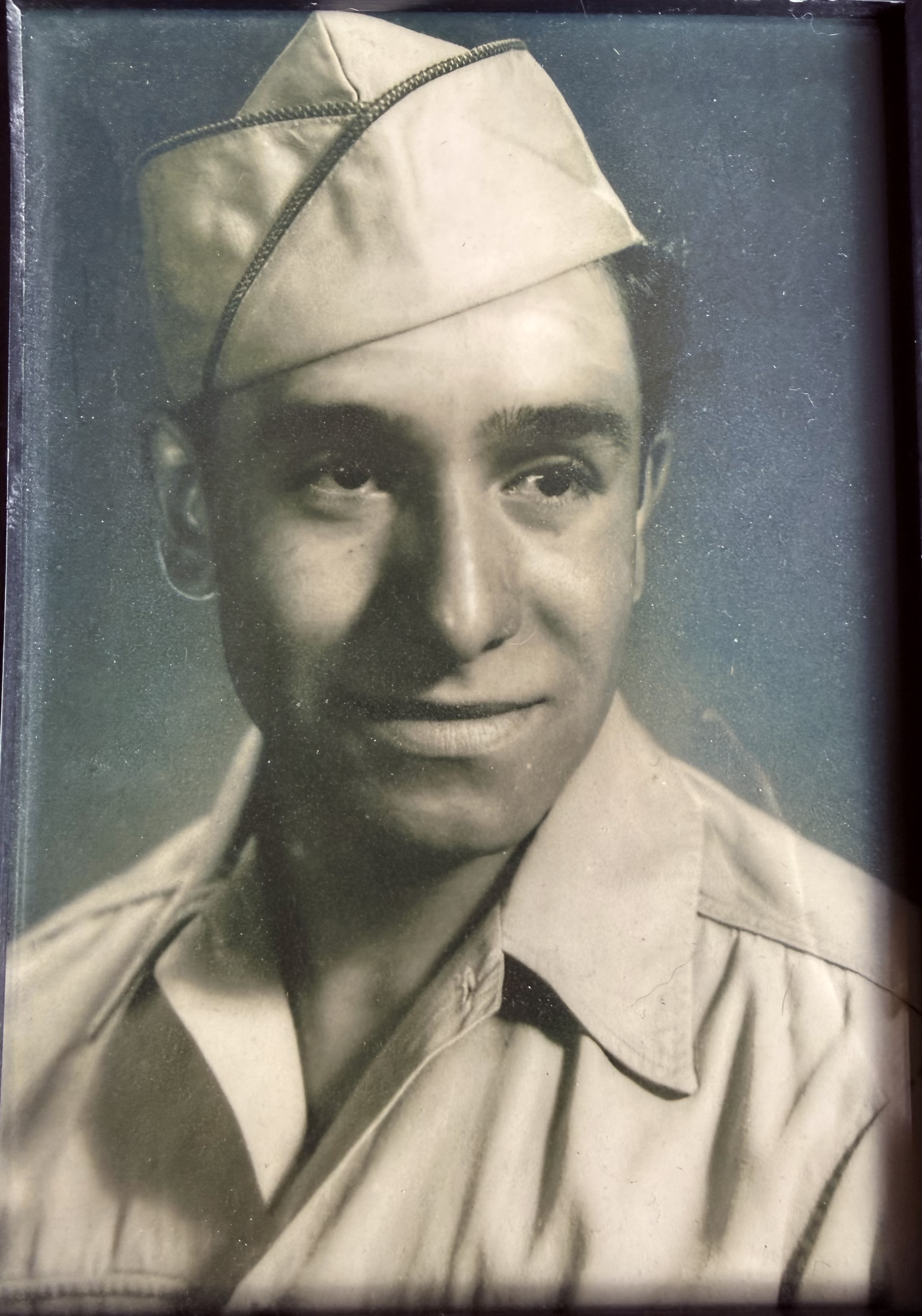 Black and white bust photo in his uniform and hat, he’s a handsome gentleman.
